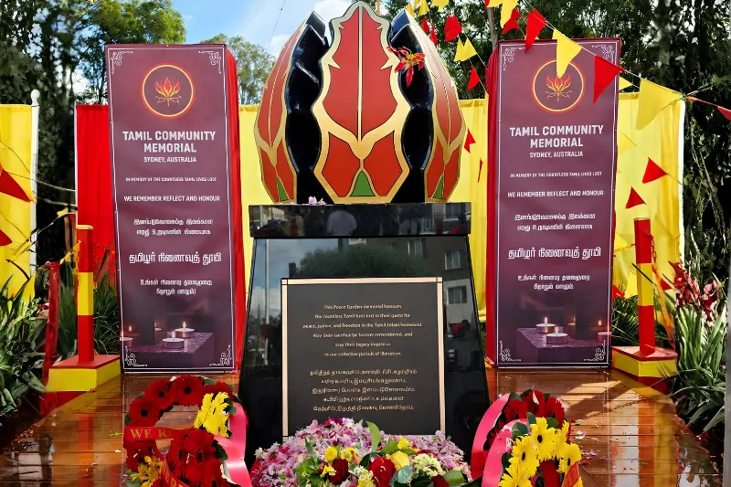 Tamil Community Memorial with floral wreaths and remembrance flowers.